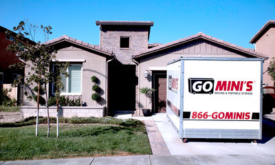 A Go Mini's moving container in a residential driveway